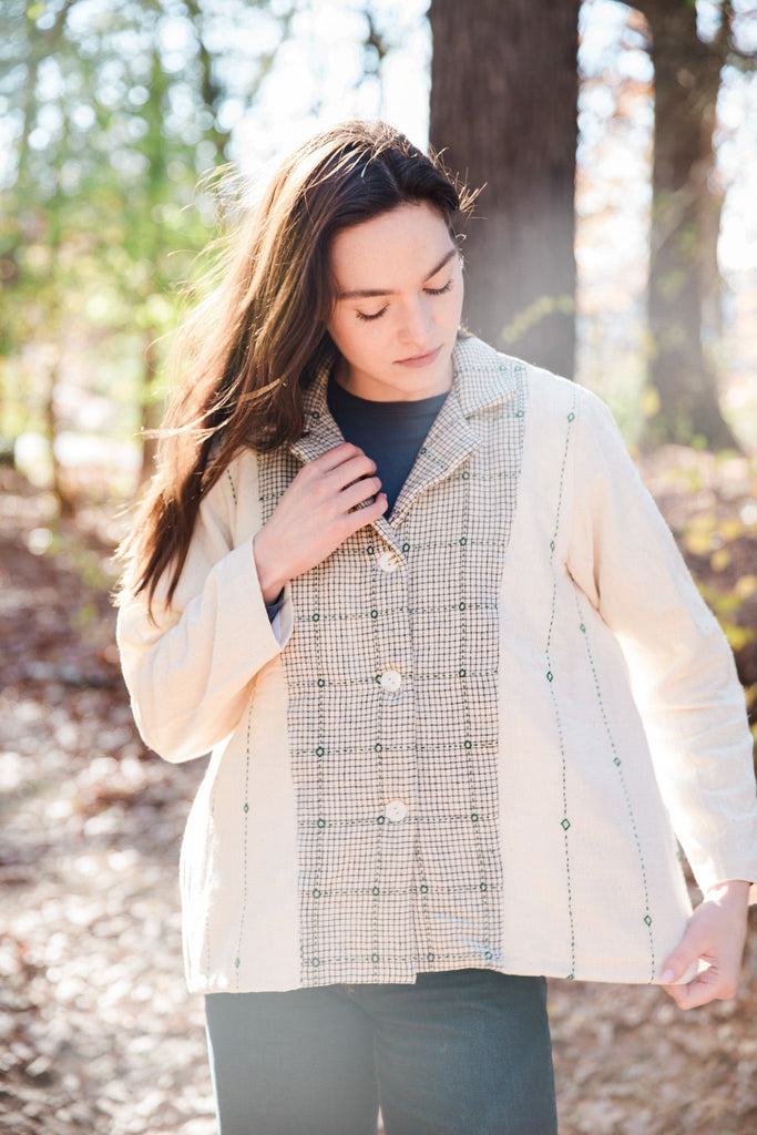 woman wearing white handloom cotton jacket in a forest setting