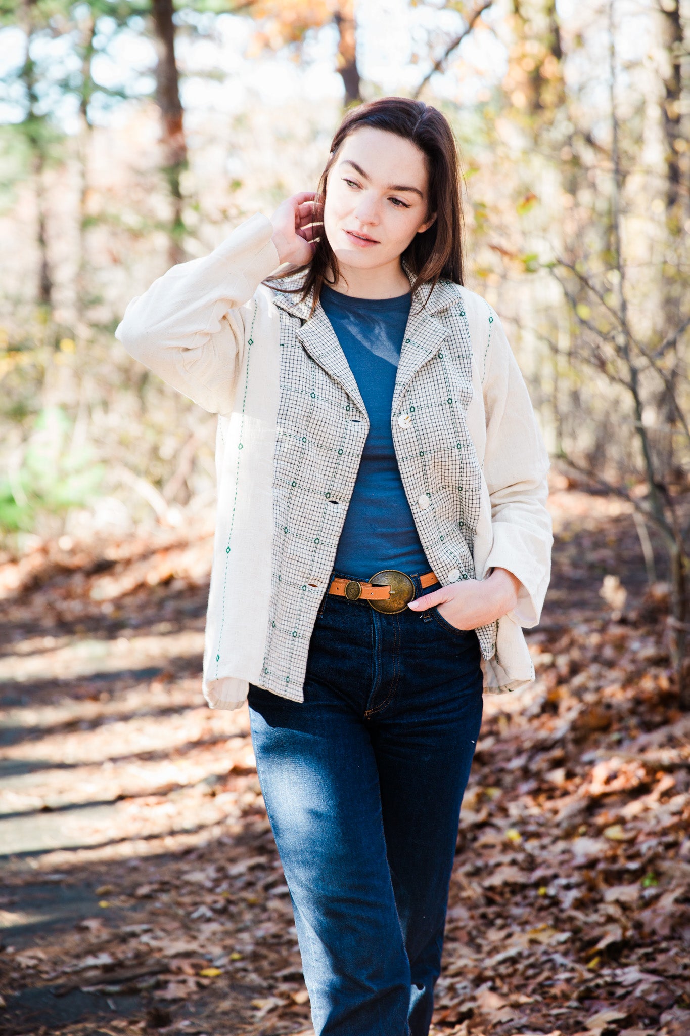 model wearing a white cotton artistic jacket in a forest setting